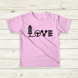 May include: Pink t-shirt with a black graphic of racing-themed icons spelling out the word "LOVE".