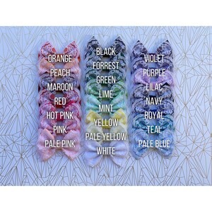 May include: A set of 20 lace hair bows in various colors, including orange, peach, maroon, red, hot pink, pink, pale pink, black, forrest green, lime, mint, yellow, pale yellow, white, violet, purple, lilac, navy, royal, and teal. The bows are arranged in two rows of ten, with the colors transitioning from orange to teal.