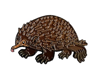 May include: A brown enamel pin depicting an echidna with a pink tongue sticking out. The echidna is walking on all fours and has a spiky back.