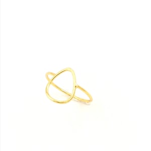 May include: A gold-toned ring with a teardrop-shaped open design.