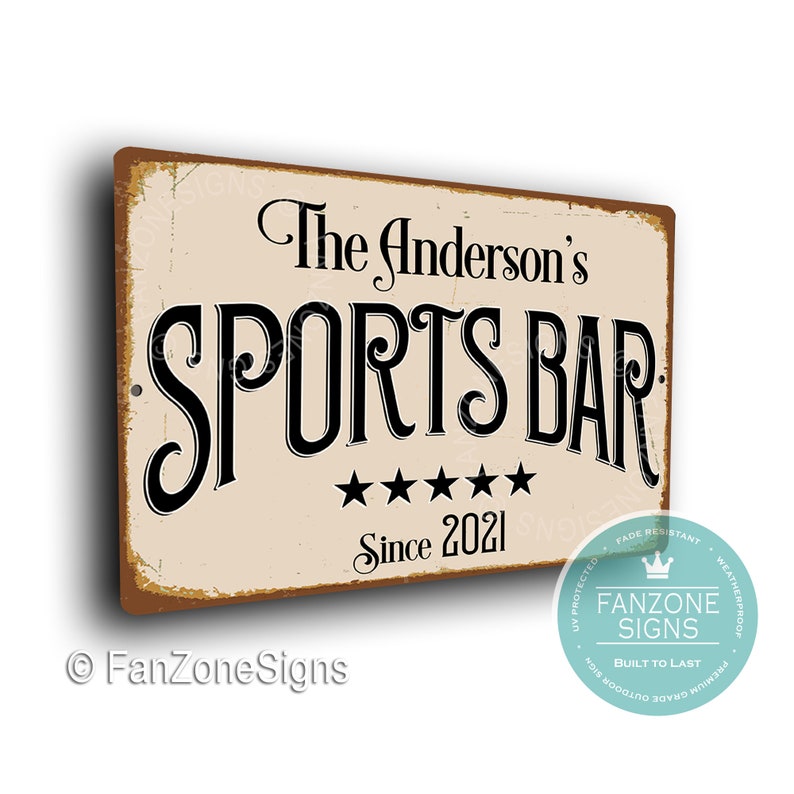May include: A vintage-style metal sign with a distressed background. The sign reads "The Anderson's Sports Bar Since 2021" with five stars below the text. The sign has a brown border and a white background.
