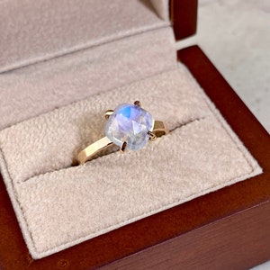 High Quality blue flashing cushion shape moonstone solitaire ring shown in gift box ready to gift. Perfect dainty delicate jewelry gift for her. Great earring present for birthday, wedding, anniversary, baby shower and June Birthdays.