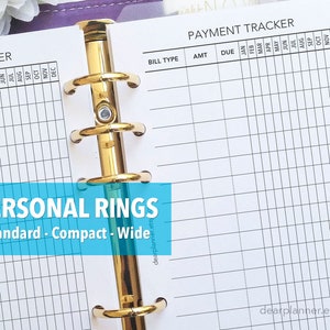 May include: A white payment tracker with a grid layout for recording bills, amounts, due dates, and monthly payments. The tracker is designed for a personal planner with gold rings.