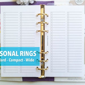 May include: A white planner insert with a checklist design, held in a purple and white binder with gold rings. The text "PERSONAL RINGS" is displayed in a blue banner, with "Standard - Compact - Wide" below it. A teal pen is visible.