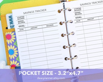 May include: White pocket-sized savings tracker inserts, 3.2" x 4.7", with sections for starting and ending balances, goal, date, amount, and balance. The inserts are held in a binder with silver rings. The text "SAVINGS TRACKER" is at the top.