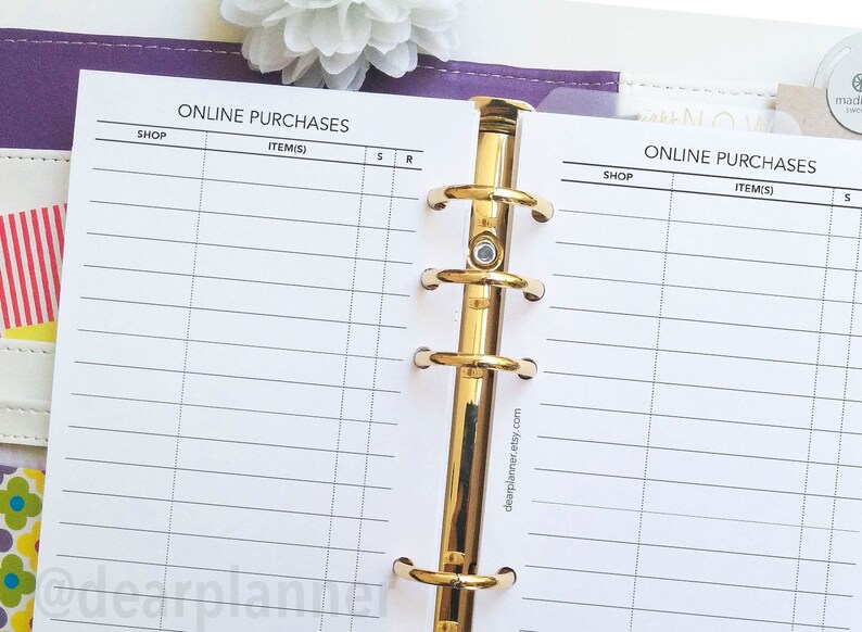 May include: A white planner page with a gold binder ring. The page is divided into columns labeled "Shop", "Item(s)", "S", and "R". The text "ONLINE PURCHASES" is at the top of the page.