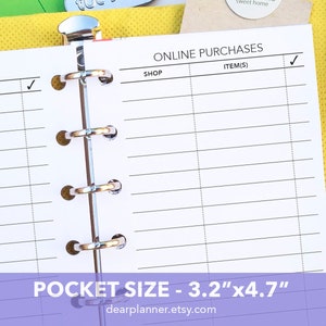 May include: A white planner with a black and white grid pattern. The planner has a silver ring binding and is labeled "ONLINE PURCHASES" and "POCKET SIZE - 3.2"x4.7"".
