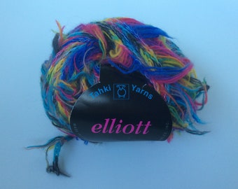 May include: A ball of multi-colored yarn with a black label that reads "Tahki Yarns elliott"