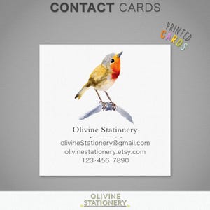 May include: A watercolor illustration of a robin perched on a branch. The illustration is on a white background with the text "Olivine Stationery" and contact information below the bird.