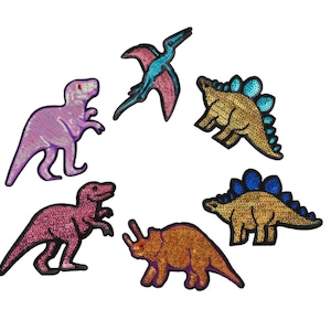 May include: Six colorful iron-on patches featuring different dinosaurs, including a pterodactyl, a triceratops, and a stegosaurus. The patches are made of sequins and have a shiny, iridescent finish.