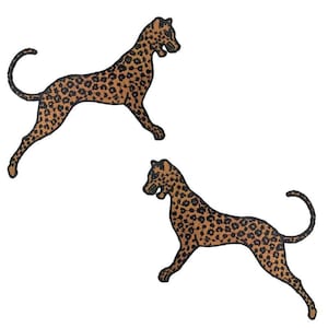 May include: Two leopard-shaped embroidered patches. Each patch has a tan base with black spots and a brown border. The leopards are shown in a running position, with their mouths open, against a white background.
