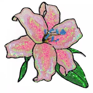 May include: A pink and green sequined lily flower patch. The flower is made of iridescent sequins and has a green stem and leaves.