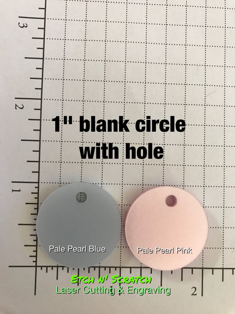 May include: Two 1-inch blank circles with holes, one pale pearl blue and one pale pearl pink. Text reads "1" blank circle with hole". The text "Etch n' Scratch Laser Cutting & Engraving" is also visible.
