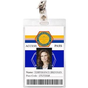 May include: A white plastic ID card with a blue and yellow design. The card has the text "Jeffersonian" and "Access Pass" printed on it. The card also has a photo of a woman with brown hair and a name tag that reads "Temperance Brennan". The pass code is 17573358.