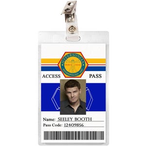 May include: A white plastic ID card with a blue and yellow design. The card has a photo of a man with brown hair and a blue shirt. The text on the card reads "Jeffersonian", "Access Pass", "Name: Seeley Booth", and "Pass Code: 12409856".
