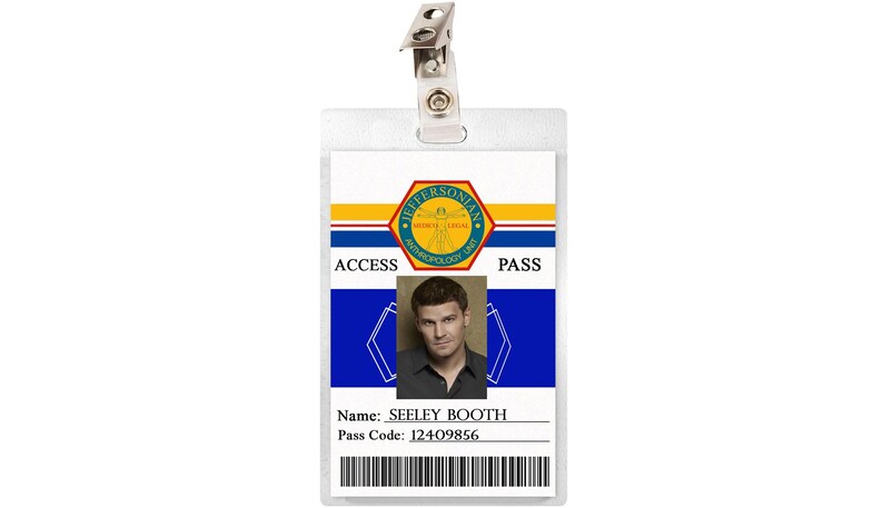 May include: A white plastic ID card with a blue and yellow design. The card has a photo of a man with brown hair and a blue shirt. The text on the card reads "Jeffersonian", "Access Pass", "Name: Seeley Booth", and "Pass Code: 12409856".