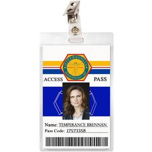 May include: A white plastic ID card with a blue and yellow design. The card has the text "Jeffersonian" in a circle with a skeleton inside. The card also has the text "Access Pass" and a photo of a woman with brown hair. The text "Name: Temperance Brennan" and "Pass Code: 17573358" is printed on the card.