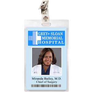 May include: A blue and white ID badge with the text "GREY+SLOAN MEMORIAL HOSPITAL" and a photo of a woman. The text "Miranda Bailey, M.D. Chief of Surgery" is below the photo.