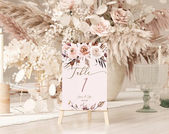 May include: A pink and brown floral table number card with the text "Table 1" and the names "James & Sofia" and the date "12.12.12".