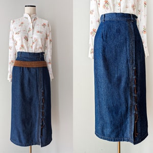 Vintage maxi denim skirt with an asymmetrical slit and lacing in a dark blue tone from the 1990s. Size S