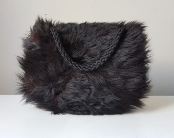 Antique long-haired muff made of black real fur with pocket