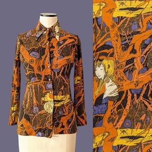 May include: A patterned long-sleeved shirt with a button-down front. The design incorporates orange, brown, and black organic shapes, with touches of purple and yellow. The shirt is displayed on a mannequin.