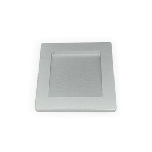 May include: A silver square cabinet pull with a recessed center.