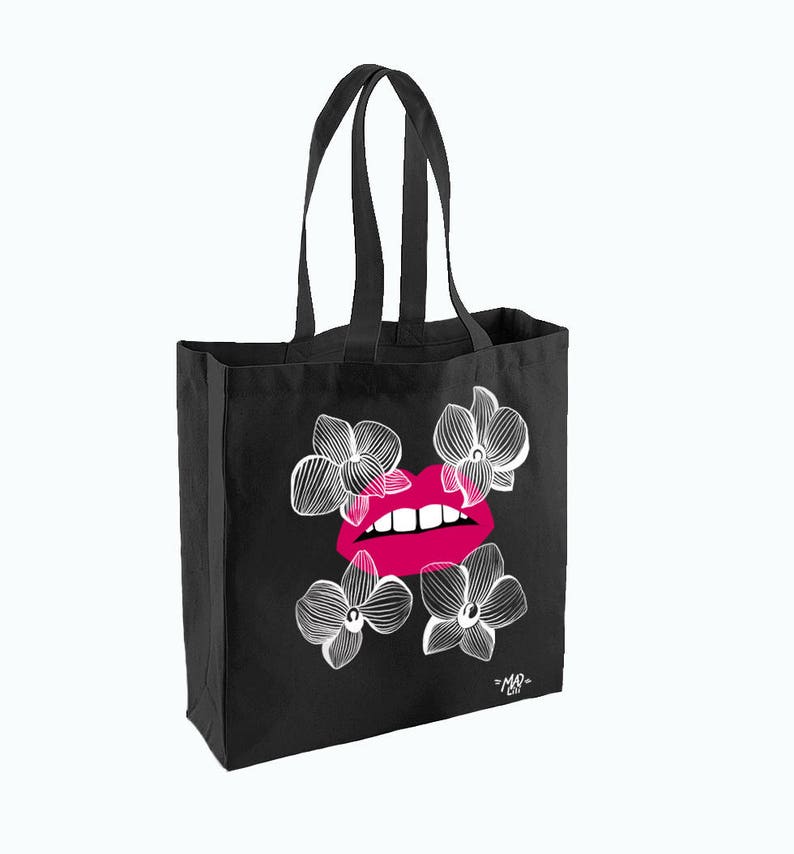May include: Black tote bag with a pink and white graphic of a pair of lips with white orchid flowers. The bag has the text "=MAR= CO" in white at the bottom.