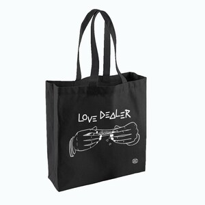 May include: Black canvas tote bag with white text that reads "LOVE DEALER" and a graphic of two hands rolling a joint.