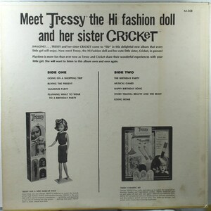May include: A vintage record album cover featuring the Tressy doll and her sister Cricket. The cover is white with black text and images of the dolls. The album is titled "Meet Tressy the Hi fashion doll and her sister Cricket". The text on the cover describes the album's contents, including songs and stories about the dolls. The album is from the 1960s.