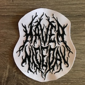 May include: White embroidered patch with the text "HAVEN MCDAN" in black, stylized in a gothic font.