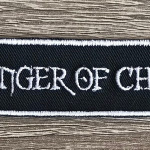 May include: Black embroidered patch with white stitching. The patch reads "Bringer of Chaos".