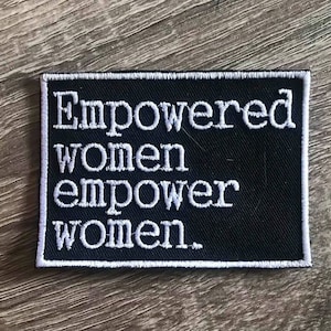 May include: Black embroidered patch with white text that reads "Empowered women empower women."