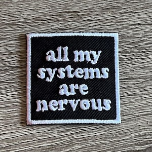 May include: Black embroidered patch with white text that reads "All my systems are nervous".