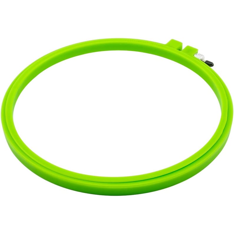 May include: A bright green plastic embroidery hoop with a screw-tightening mechanism.