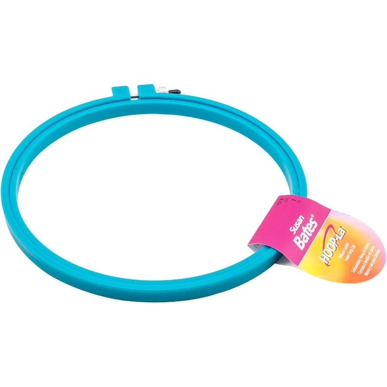May include: A blue plastic embroidery hoop with a pink and yellow label that says "Susan Bates HoopLa Embroidery Hoop 6-Inch (15.2 cm)"