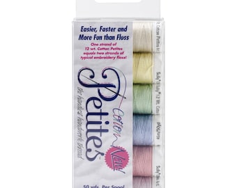May include: A package of six spools of Cotton Now! Petites embroidery floss. The spools are in shades of pink, blue, green, yellow, and white. The package says "Easier, Faster and More Fun than Floss" and "One strand of 12 wt. Cotton Petites equals two strands of typical embroidery floss!" The package also says "50 yds. Per Spool Machine Washable 100% Cotton 12 wt."