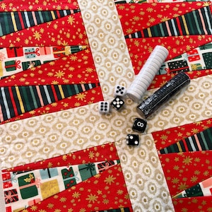 May include: A festive Christmas-themed game board with a red and gold gift box design. Includes dice and two sets of game pieces, one white and one black. The board is decorated with gift boxes and gold stars.