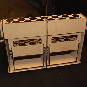 May include: A light brown wooden organizer with multiple compartments. The organizer has a series of circular holes at the top and rectangular slots on the front. It appears to be designed for storing small items.