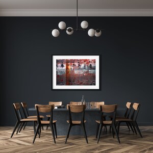 May include: A dark dining room with a black table and six chairs. A framed abstract painting hangs on the wall above the table. A chandelier with five white globe lights hangs from the ceiling.
