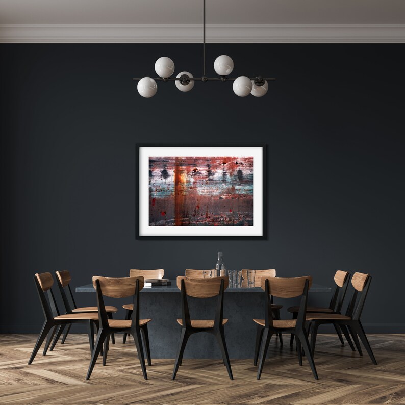 May include: A dark dining room with a black table and six chairs. A framed abstract painting hangs on the wall above the table. A chandelier with five white globe lights hangs from the ceiling.