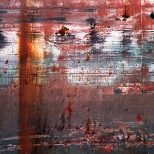 May include: Abstract background with layers of red, brown, white, and blue paint. The paint is chipped and peeling, creating a textured surface.