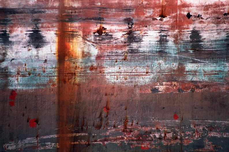 May include: Abstract background with layers of red, brown, white, and blue paint. The paint is chipped and peeling, creating a textured surface.