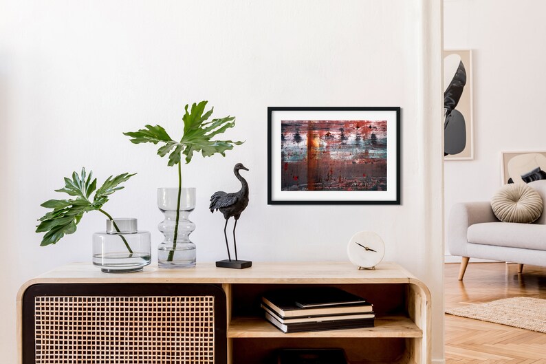 May include: A black and white abstract painting in a black frame hangs on a white wall above a wooden shelf with a black crane figurine, two clear glass vases with green plants, and a white clock.