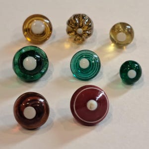 Swirlback glass buttons.  Clear with white centers.  3 yellow/orange. 3 green. 2 red.