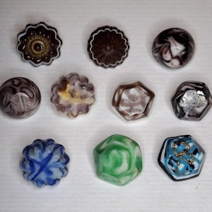 Swirlback glass buttons.  Molded, fancy, opaque marbled.