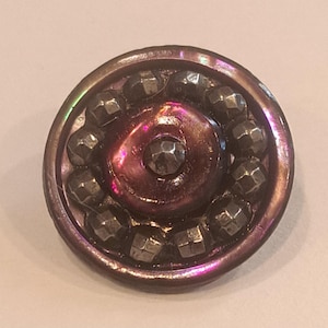 May include: A white ceramic mug with a black handle and the text "But First, Coffee" in a black, handwritten-style font. The mug is on a white surface.