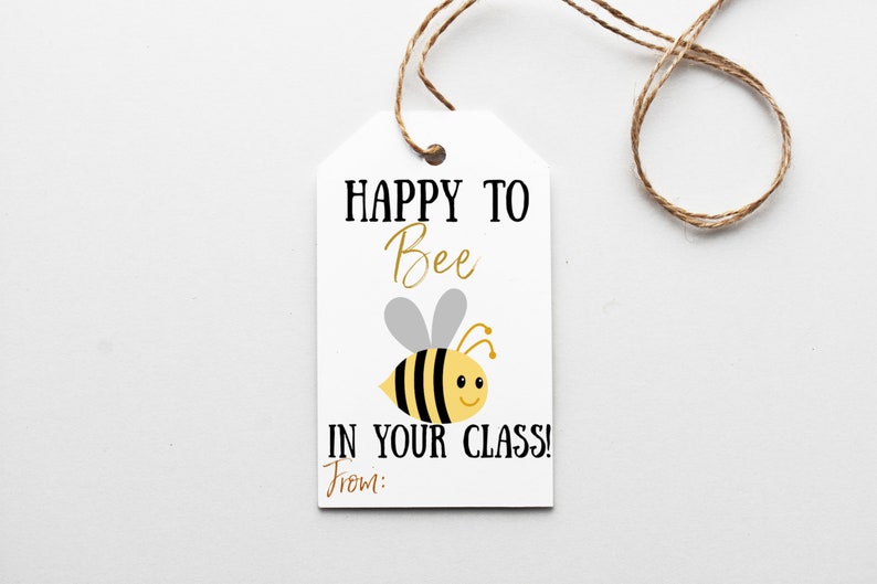 May include: White gift tag with a bee illustration and the text "Happy to Bee in your class!" with a space for a name to be written below.