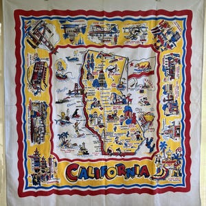 May include: A vintage yellow and blue tablecloth with a map of California. The map features various cities and landmarks, including San Francisco, Los Angeles, and Yosemite National Park. The tablecloth has a red, white, and blue border and the word "CALIFORNIA" in large, bold letters.