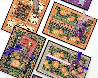 May include: Five Halloween-themed greeting cards with black borders and various designs. The cards feature pumpkins, bats, cats, witches, and the words "No Tricks All Treats", "Broom Spell", "Oh Bats", "Fright Night", and "Charmed".